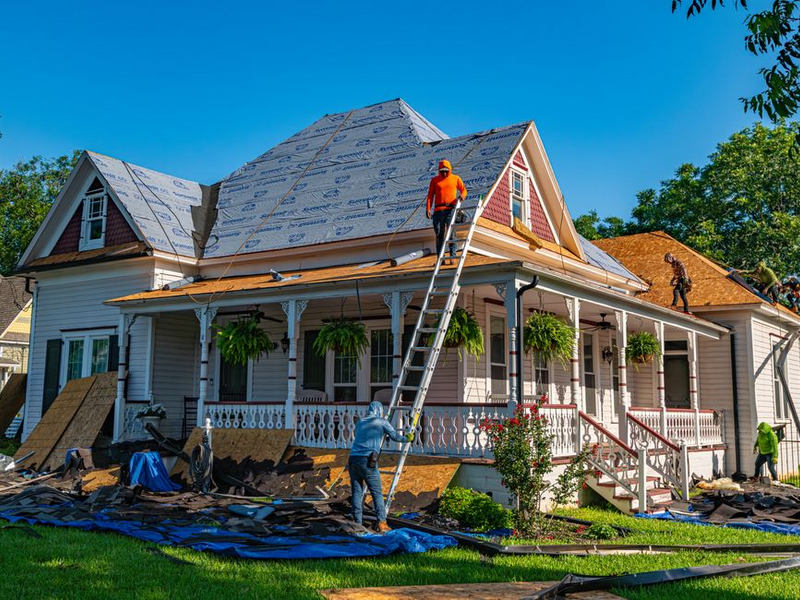Signature Exteriors crew performing a free roof inspection