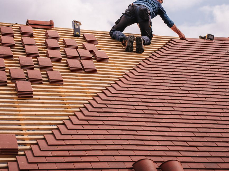Signature Exteriors technician performing roof maintenance and repair in Spokane